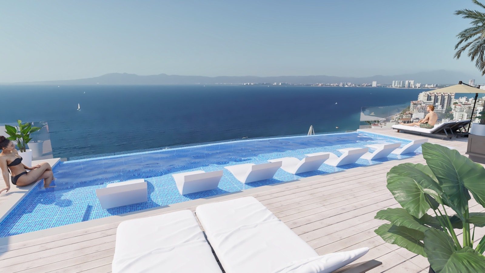Infinity pool overlooking the ocean with lounge chairs.